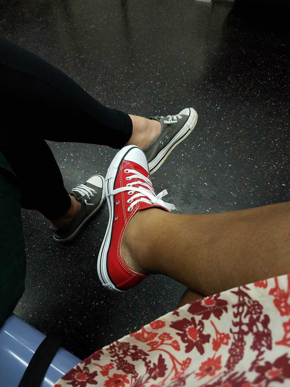 Photo of Chuck Taylors - Converse. One red, one gray