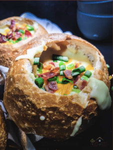 A bowl of copycat Panera rustic baked potato soup loaded with bacon, cheddar, and chives.