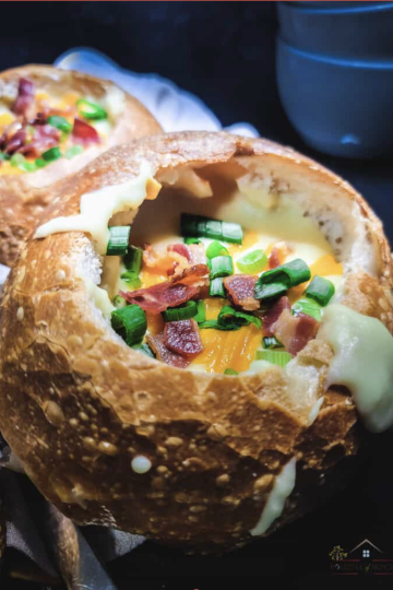 A bowl of copycat Panera rustic baked potato soup loaded with bacon, cheddar, and chives.