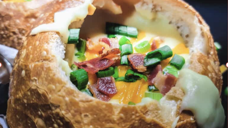 A bowl of copycat Panera rustic baked potato soup loaded with bacon, cheddar, and chives.